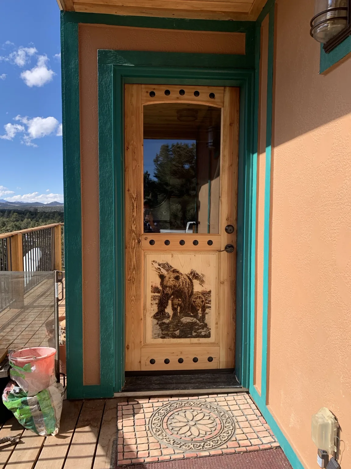 Installed bear-engraved glass entry door