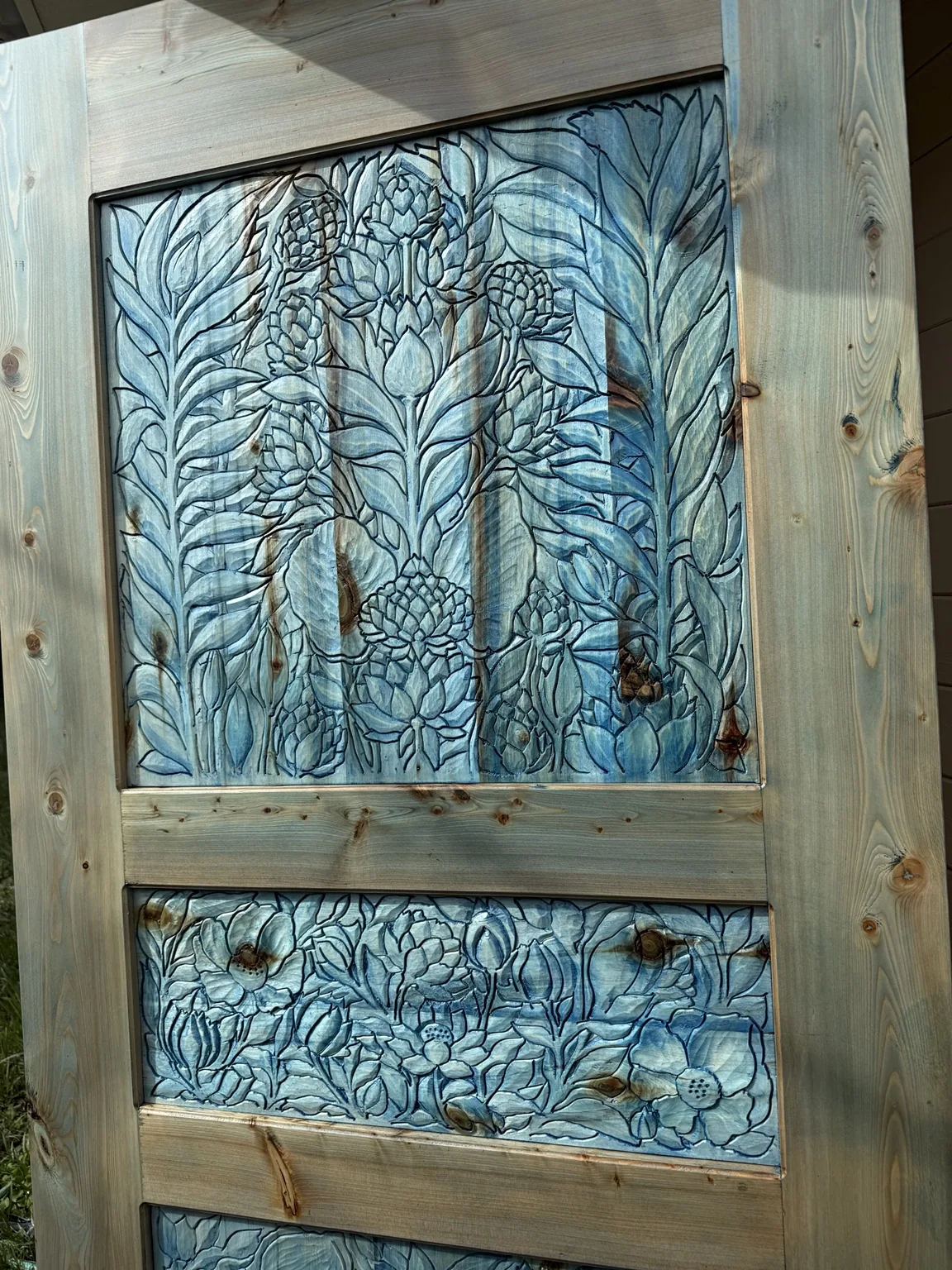 Close-up of blue floral carved panel