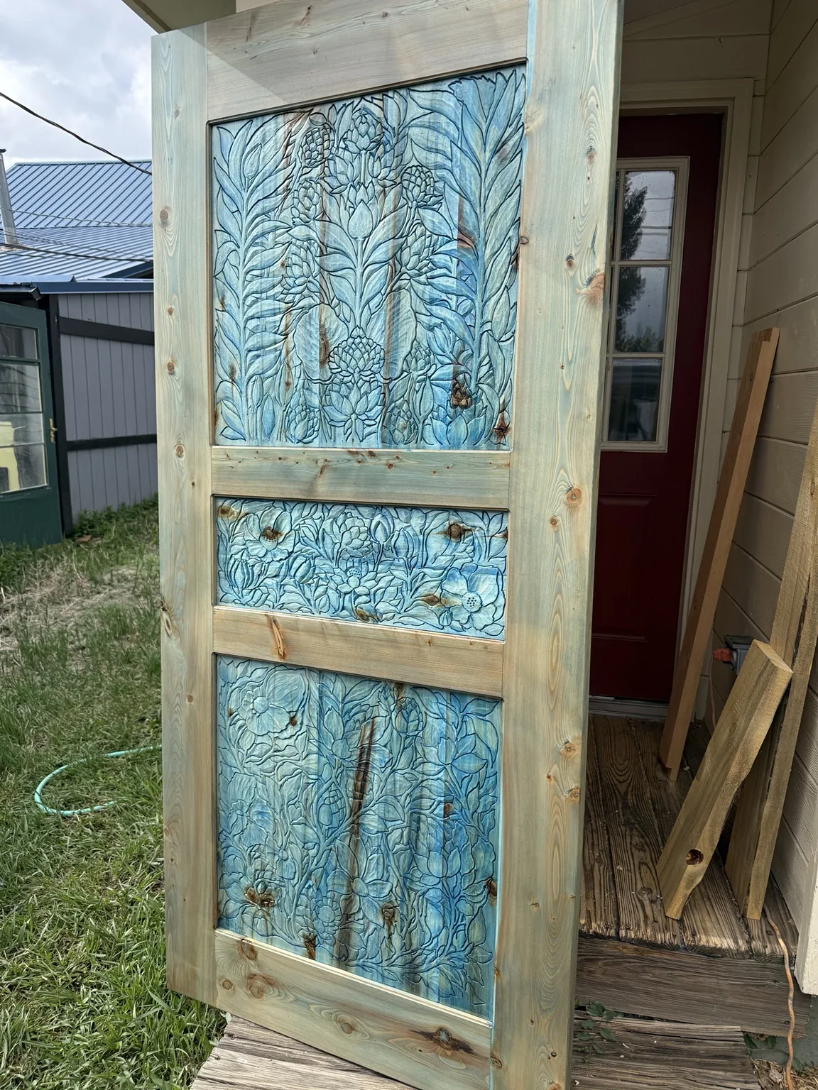Three-panel blue floral carved door