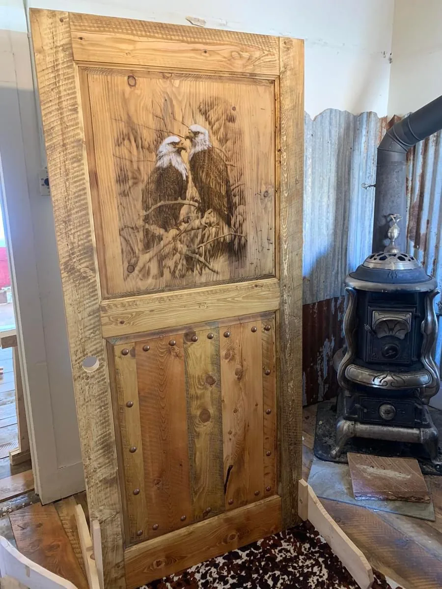 Rustic solid wood door with detailed eagle artwork