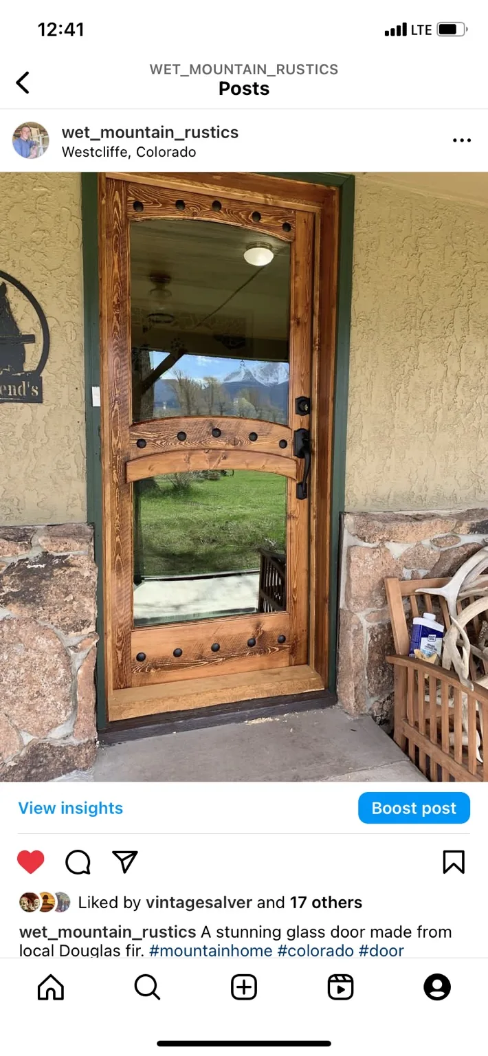 Custom Douglas fir glass entry door with decorative clavos