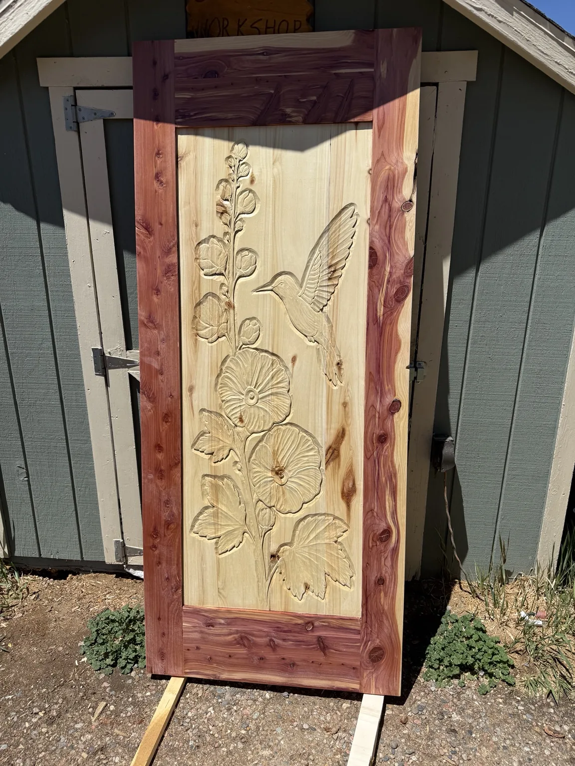 Carved hummingbird and hollyhock door