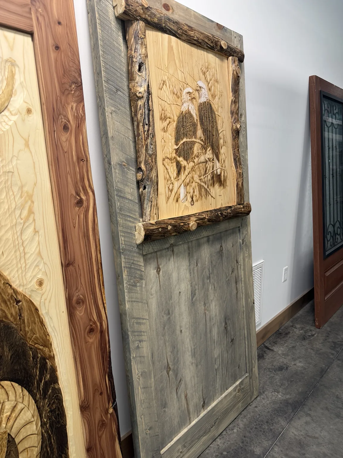 Rustic eagle door with natural log trim